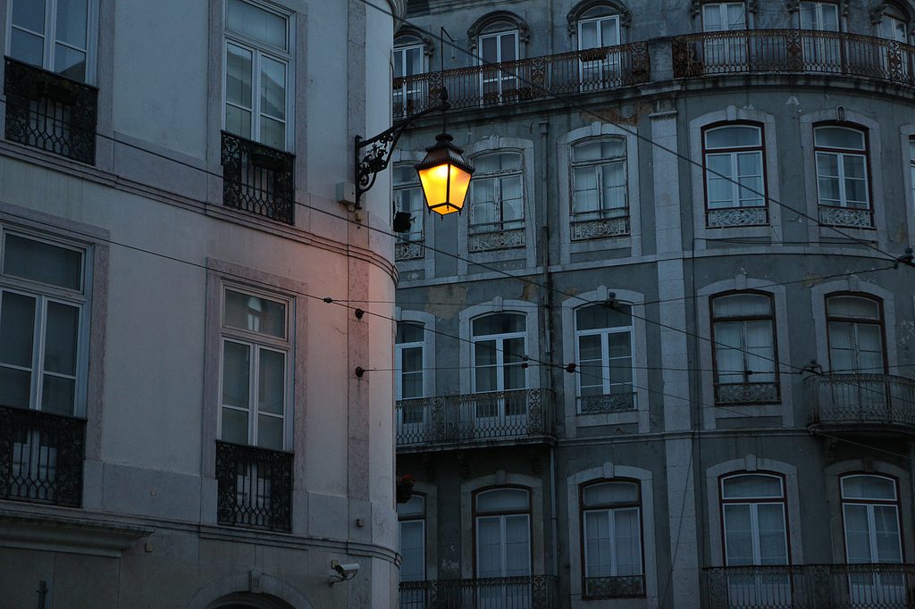 a single lamp glooming during the night in Lisbon