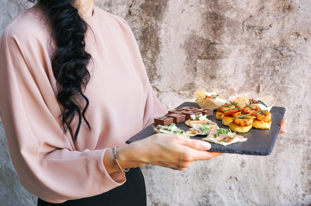 Estate agent preparing canapes to serve on an open house